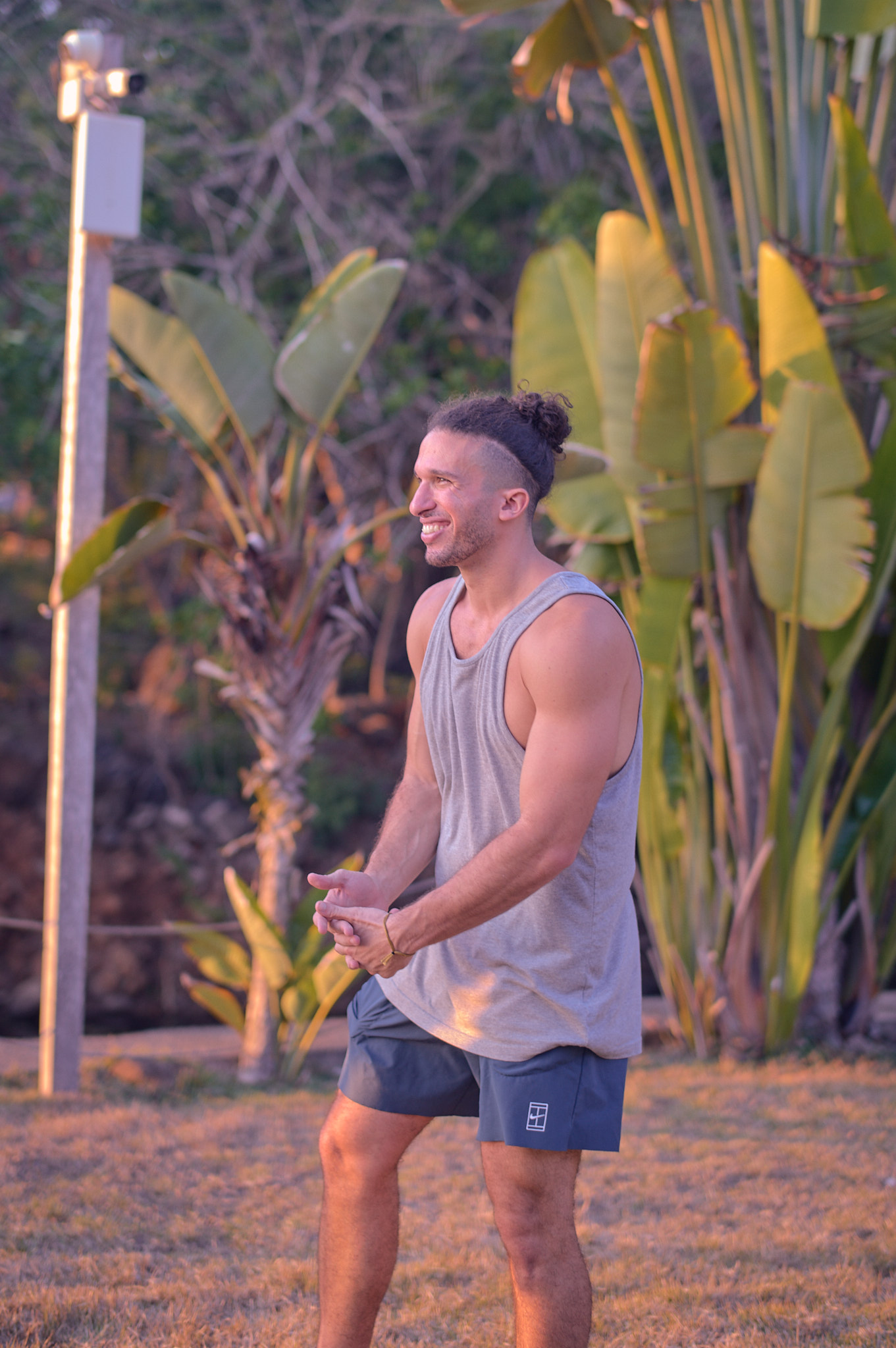 Editorial portrait of Jonah Kest in front of bird-of-paradise plants at golden hour, Mexico 300hr Teacher Training.